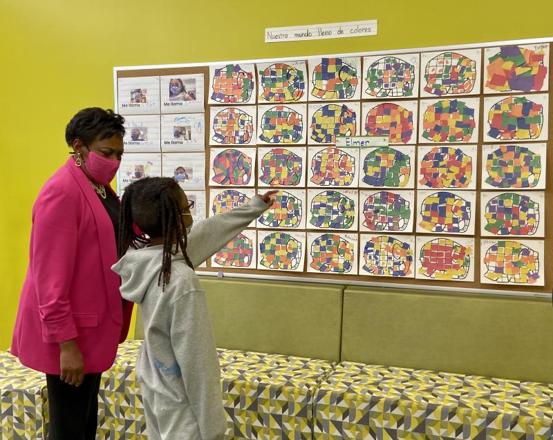 Third-grader Ky’leak Whaley shows NEA President Becky Pringle examples of work completed by the school’s Spanish immersion program students.